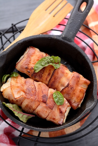 pieces,of,cod,wrapped,in,bacon,on,a,cast,iron