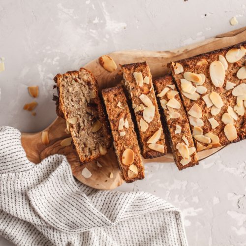 homemade,vegan,banana,bread,with,almonds,and,chocolate,,gray,background.